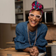 Chef Carla Hall smiling in a kitchen